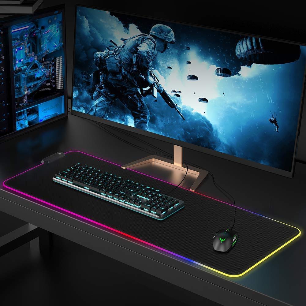 Gaming setup with a large monitor, keyboard, and rgb gaming mouse pad