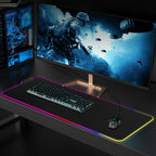 Gaming setup with a large monitor, keyboard, and rgb gaming mouse pad